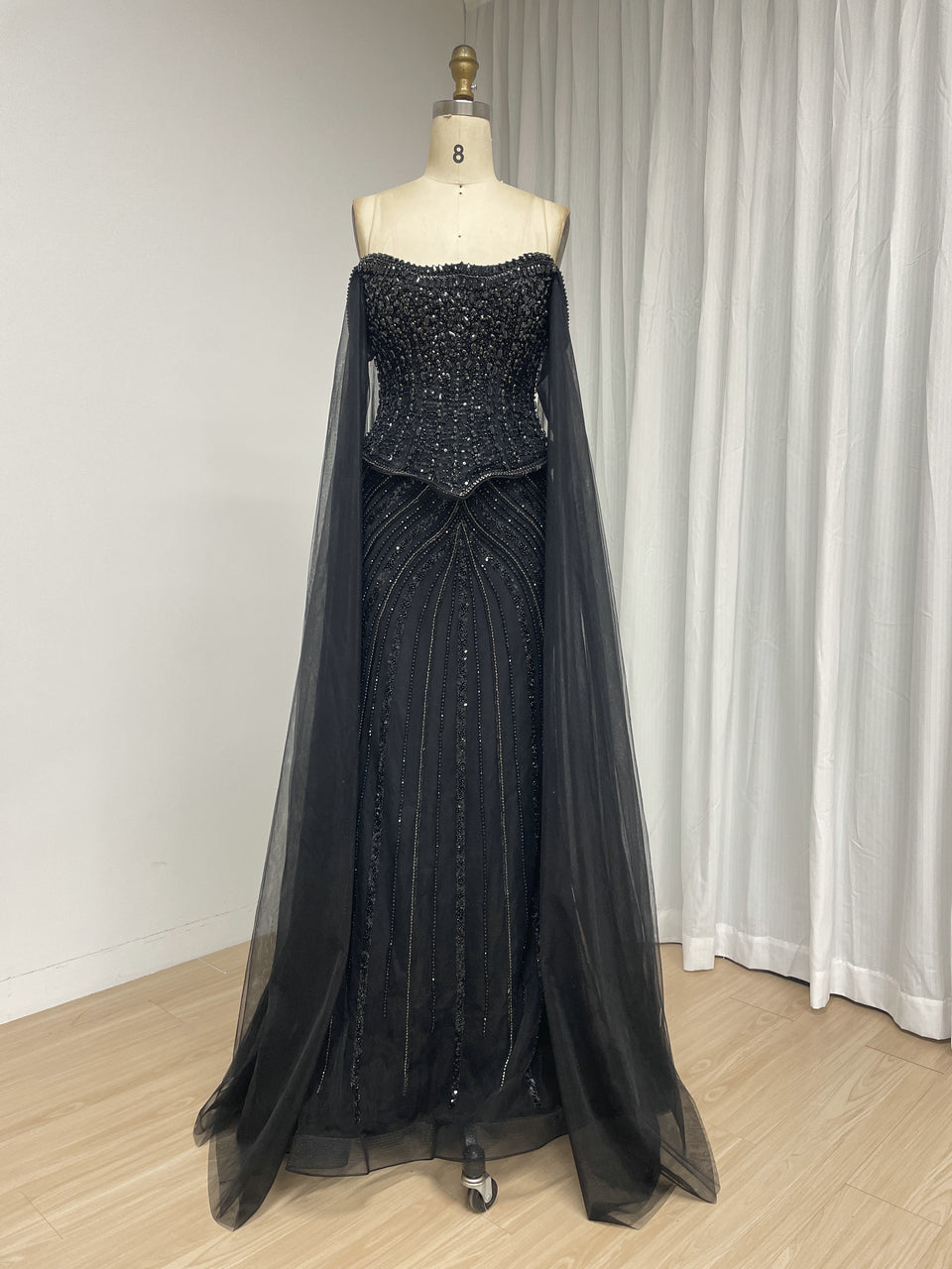 Black Beaded Evening Gown with Sheer Draped Cape Sleeves and Corset Bodice MC20187
